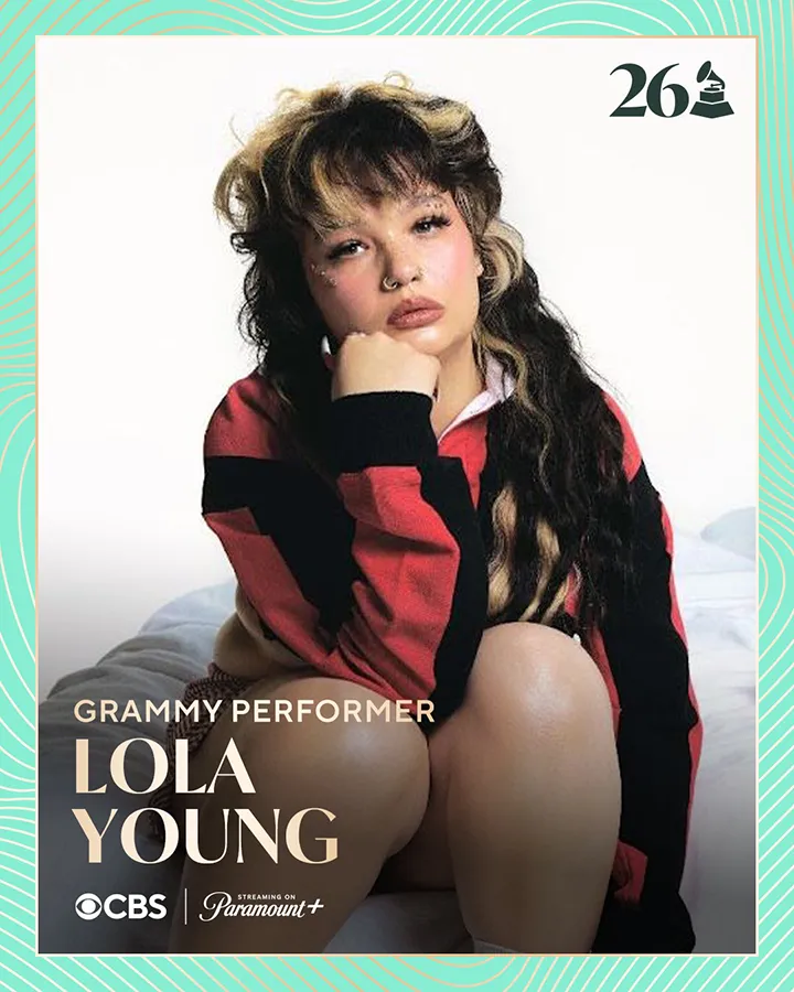 A promotional image of a Grammy performer named Lola Young, seated with a thoughtful expression, wearing a red and black striped sweater.